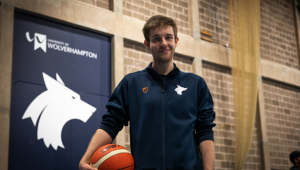 a student holding a basketball